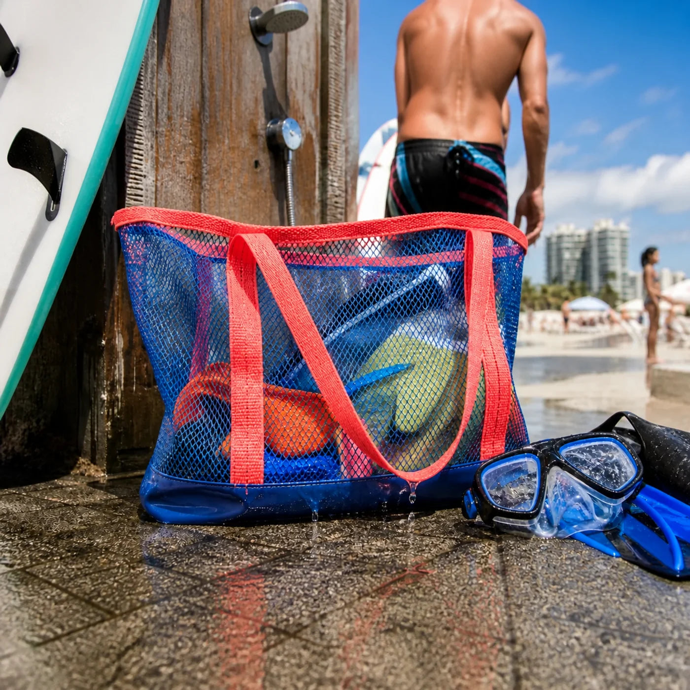 Square view of colorful sand-free mesh beach tote with water sports gear