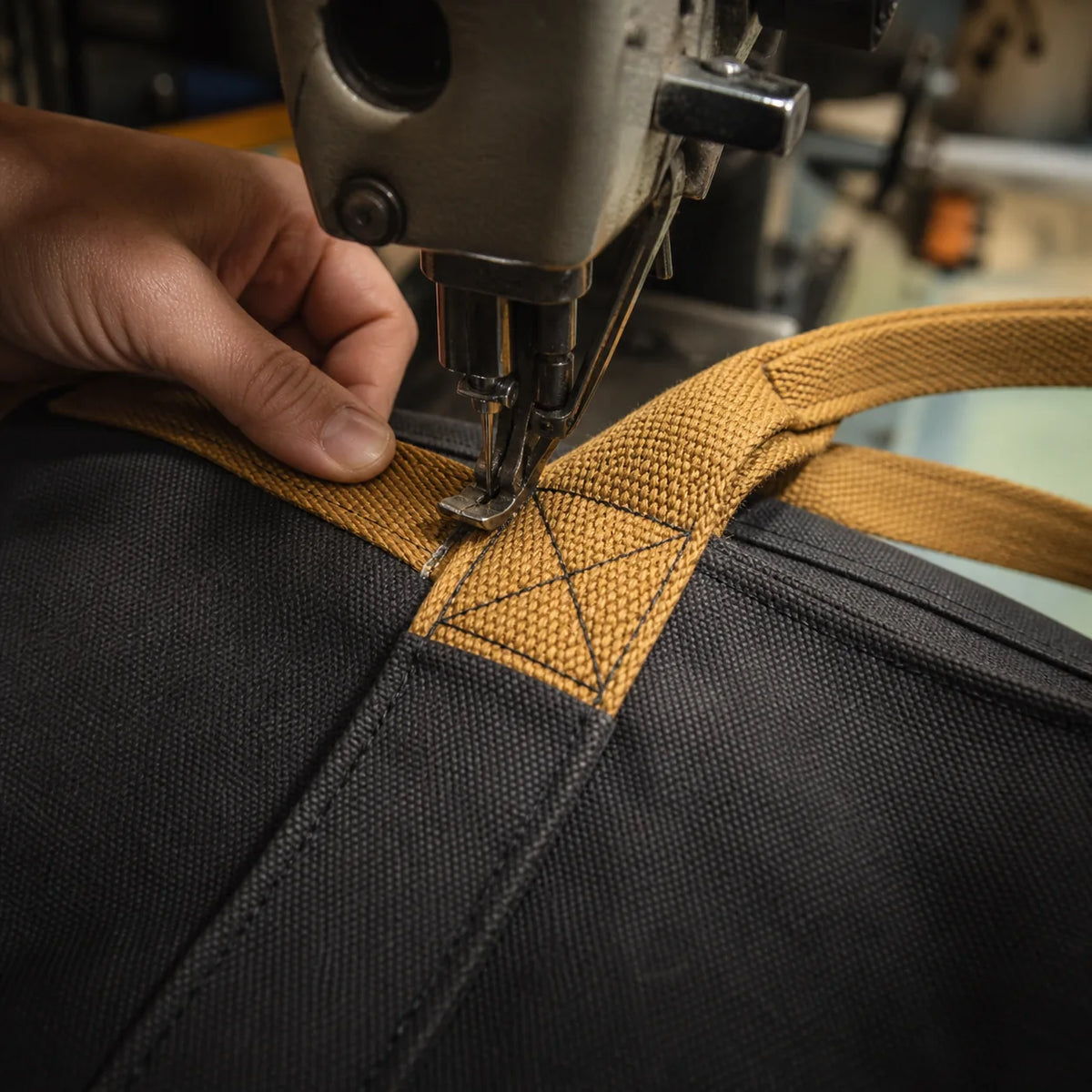 Industrial sewing of reinforced cotton webbing with cross-box stitching on a canvas tote