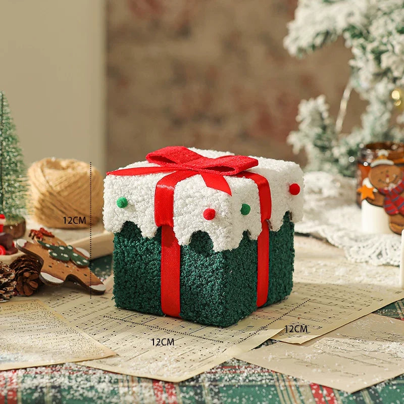 Green plush Christmas gift box with white trim and a red ribbon