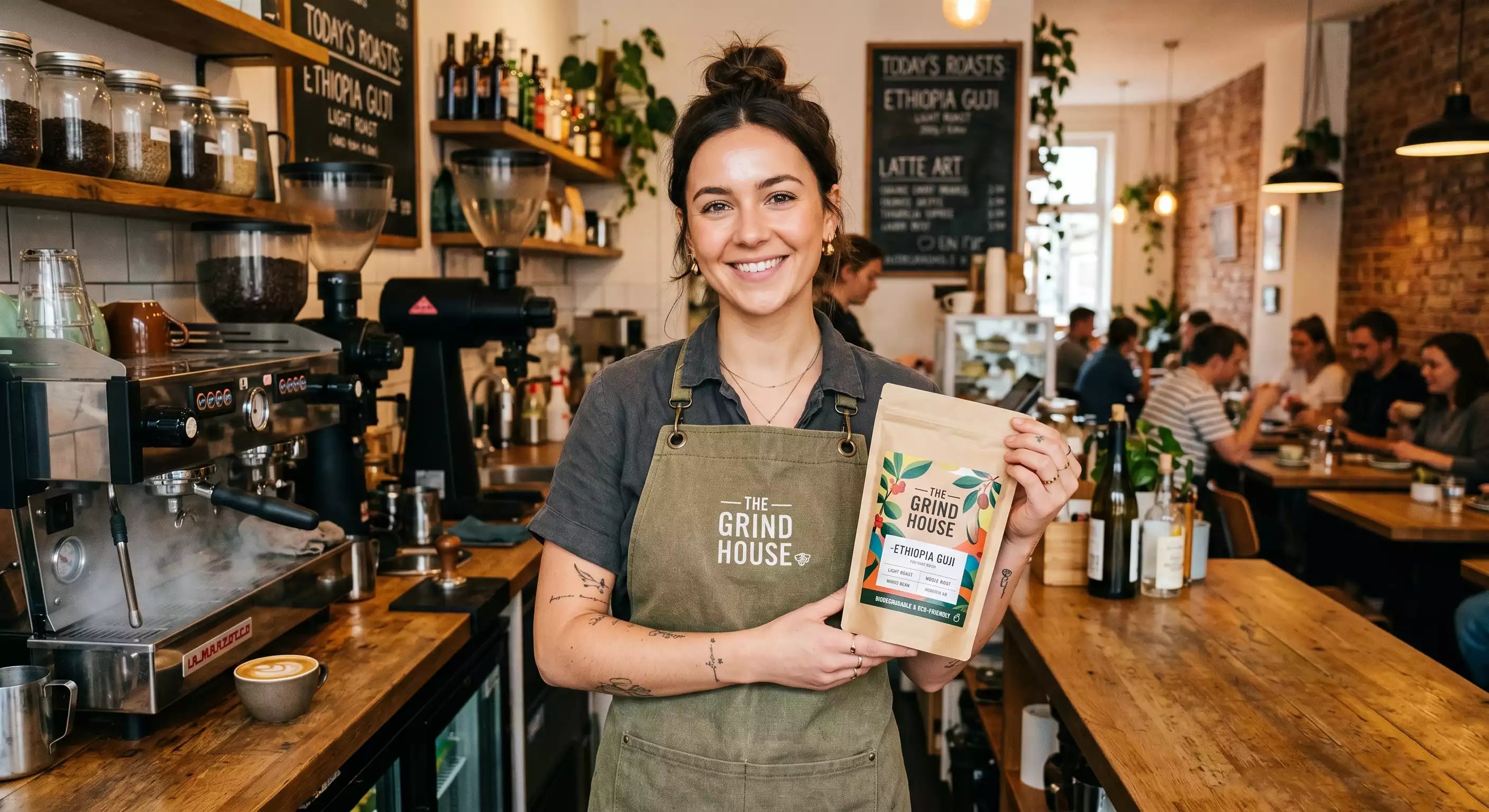 A barista proudly holding a fully compostable Custom PLA Bag of coffee.