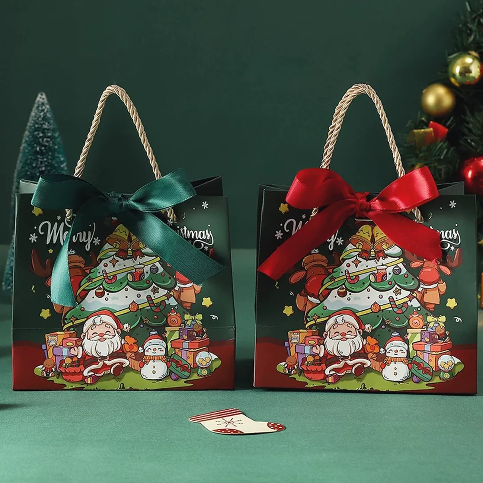 Dark-green and red ribbon-handle Christmas paper gift bags displayed together