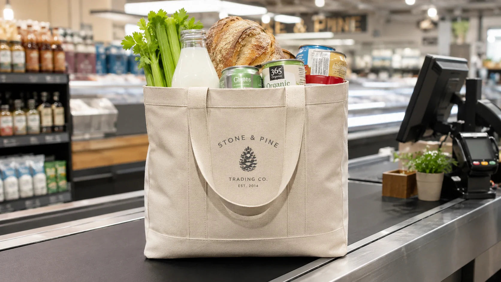 A durable, heavily loaded custom shopping bag sitting on a supermarket checkout counter filled with fresh produce and groceries.
