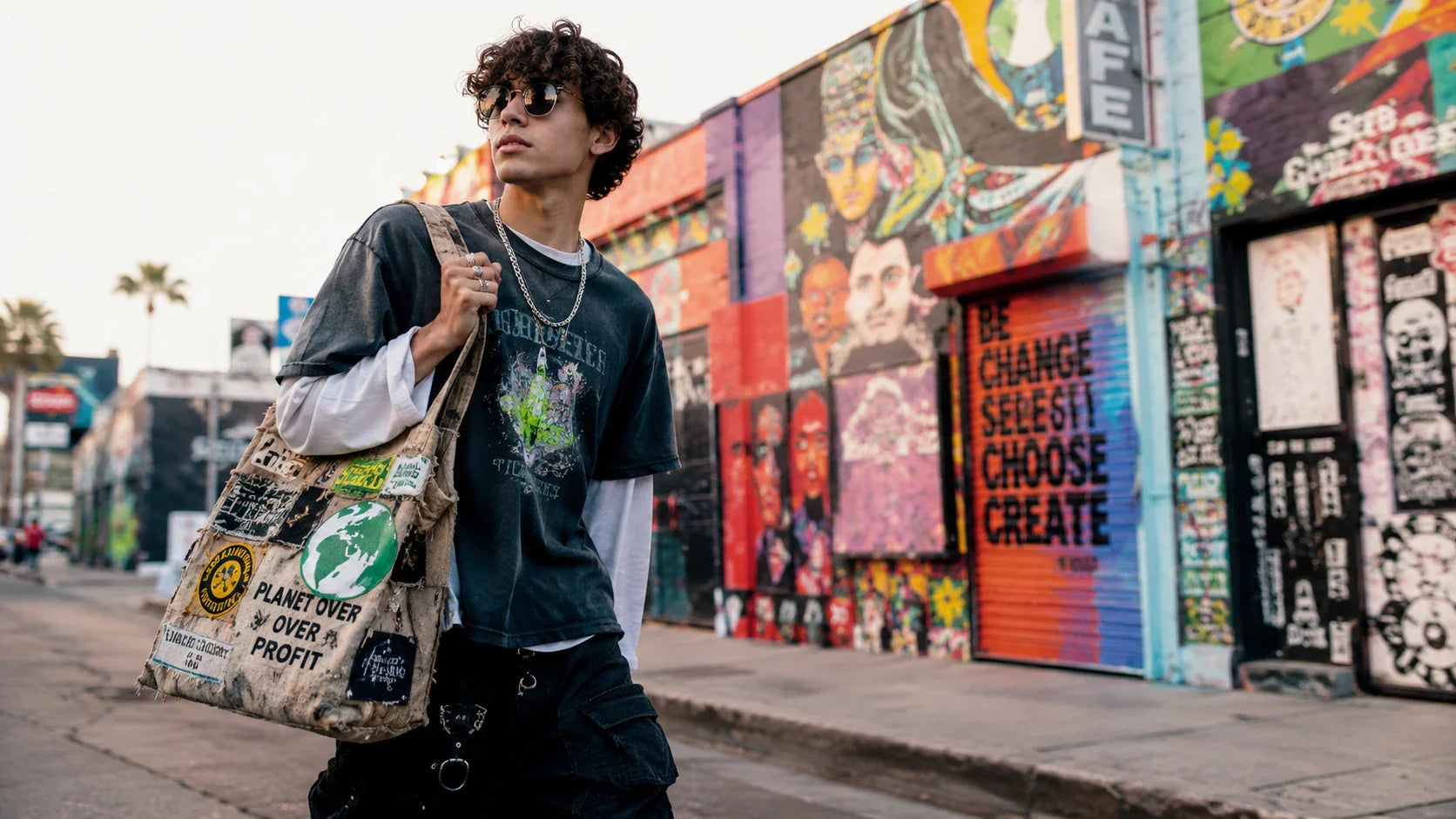 A stylish Gen Z consumer carrying an art-printed recycled tote bag in an urban setting.