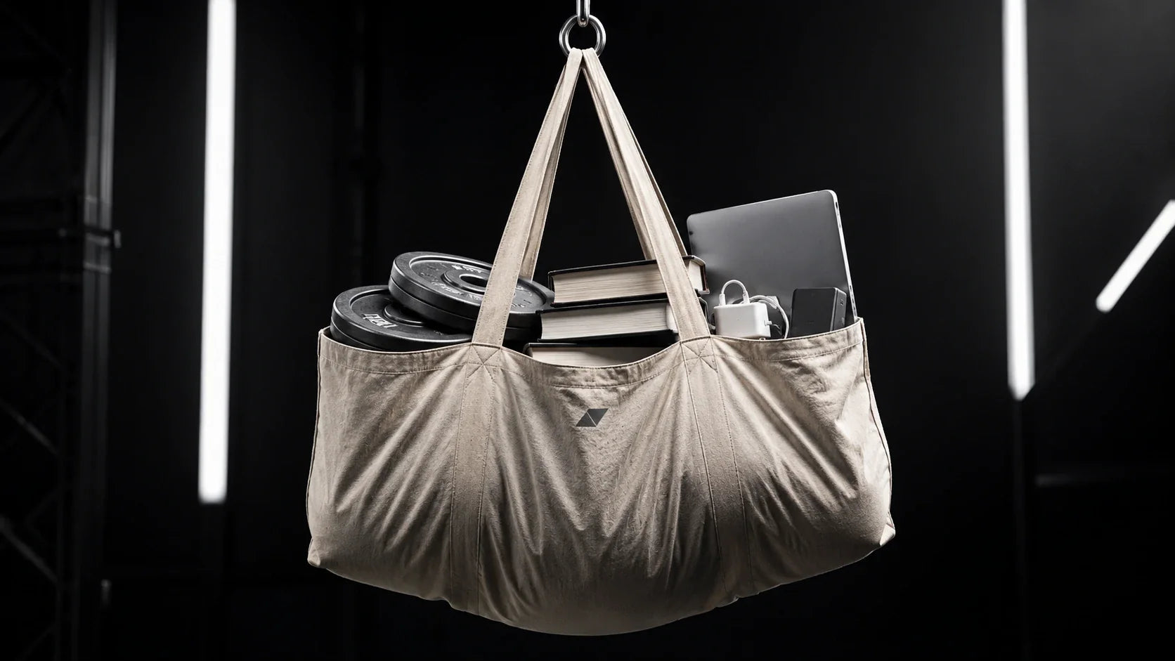 A dramatic demonstration of a large recycled tote bag carrying heavy weights to prove its extreme durability.