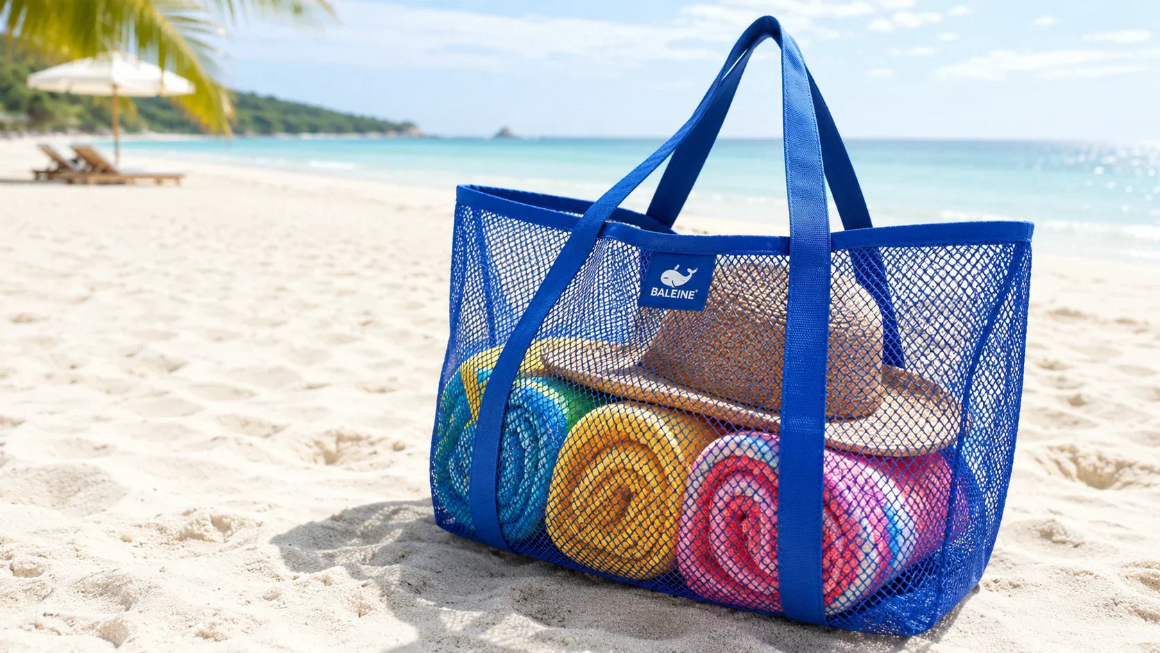 A vibrant personalized mesh beach bag sitting on a sandy beach, showcasing its breathable and sand-free design.
