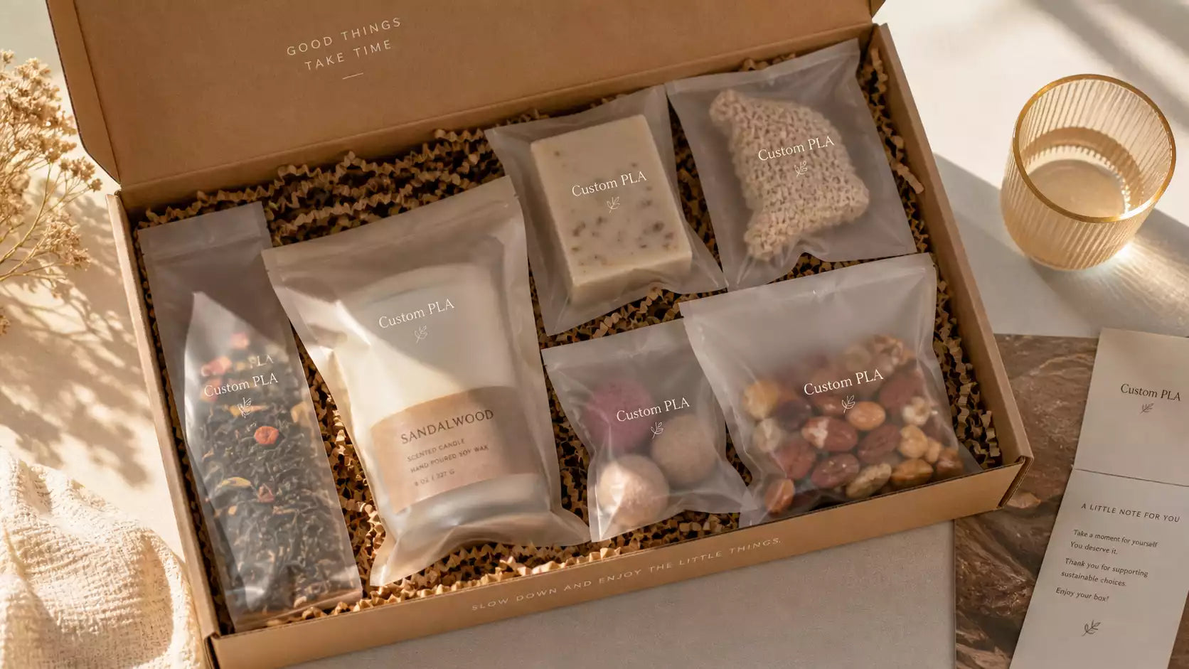 A beautiful subscription box filled with items wrapped in frosted Custom PLA Bags.