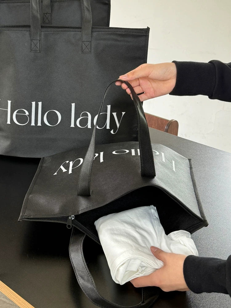 Black zippered non-woven tote bags for apparel and retail packaging