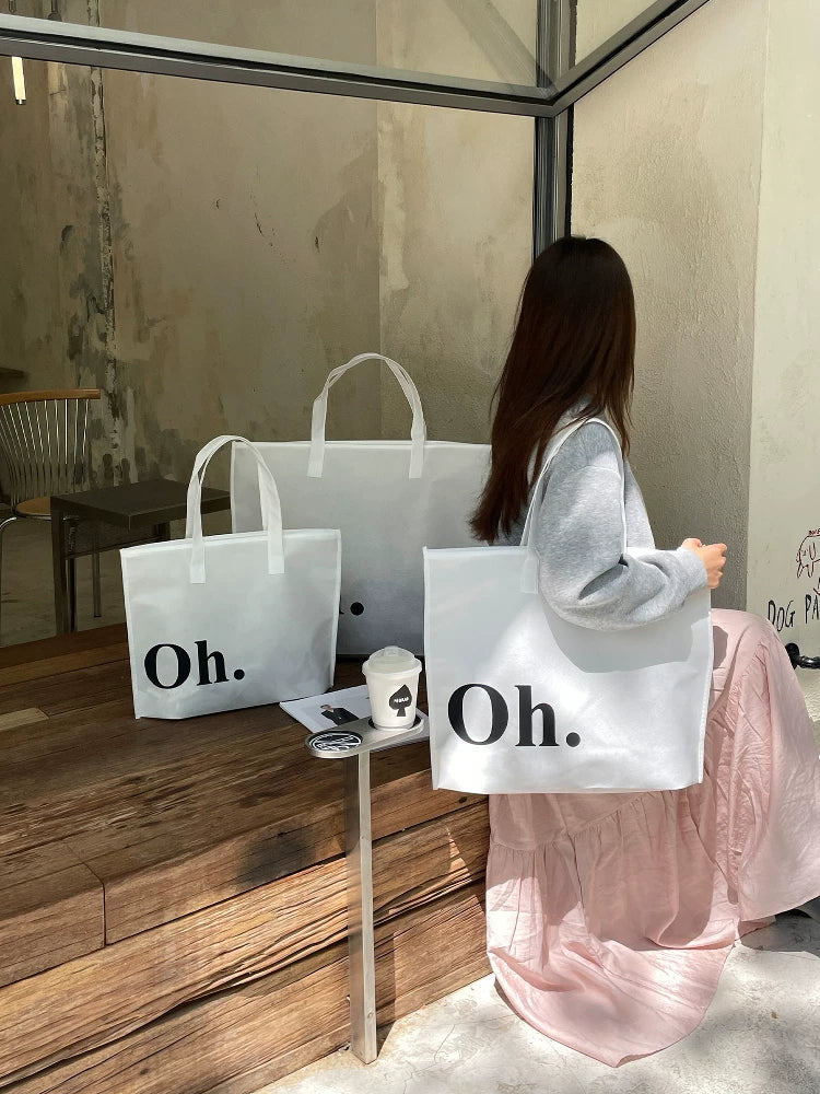 White Oh zippered non-woven tote bags in three sizes