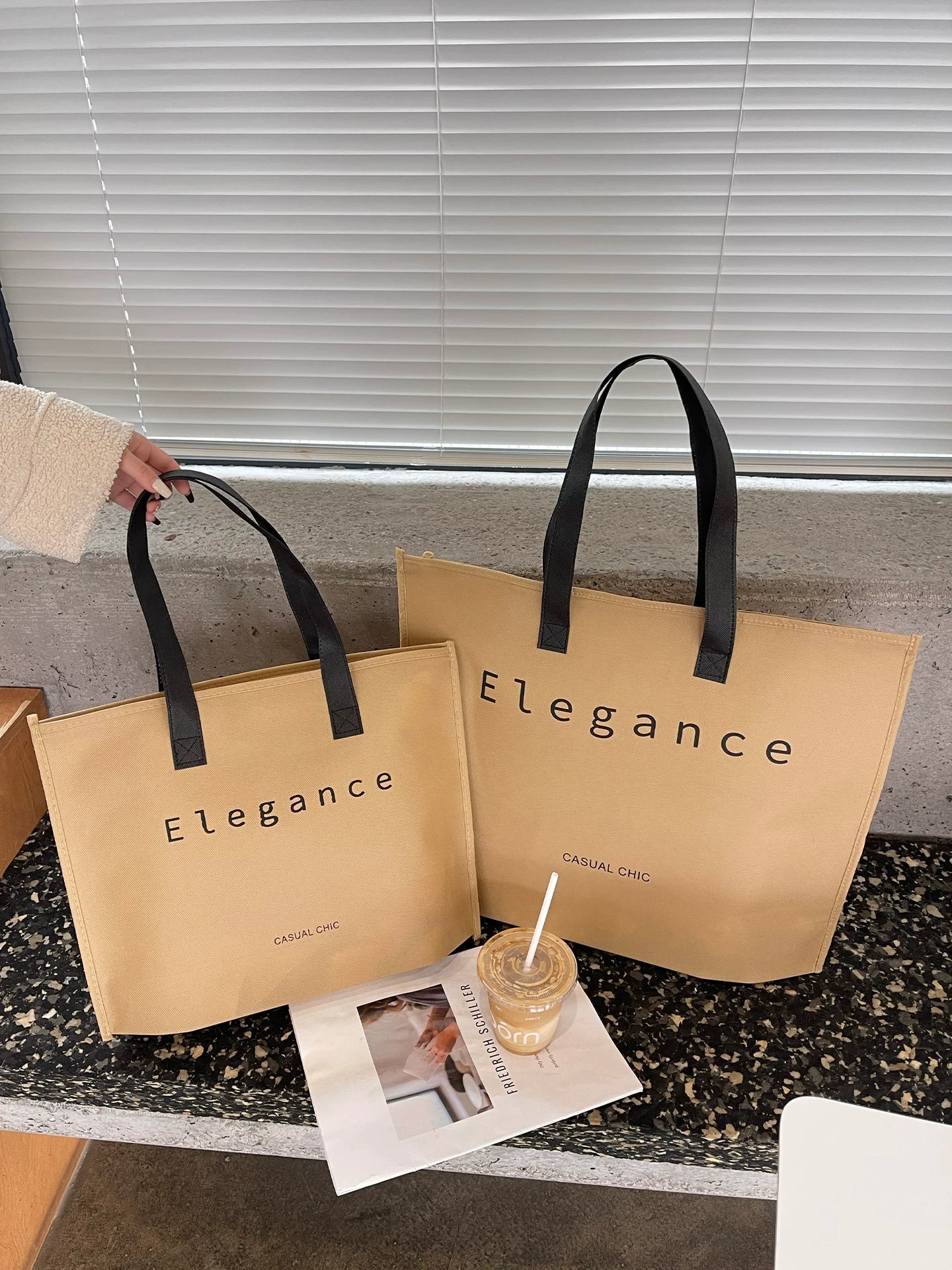 Tan zipper non-woven tote bags shown in three sizes
