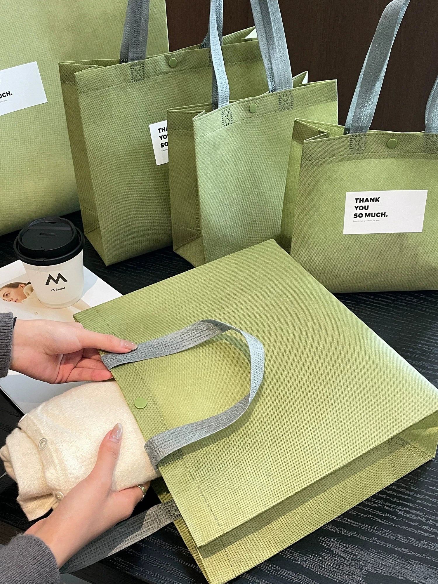 Reinforced construction of a matcha green non-woven tote bag