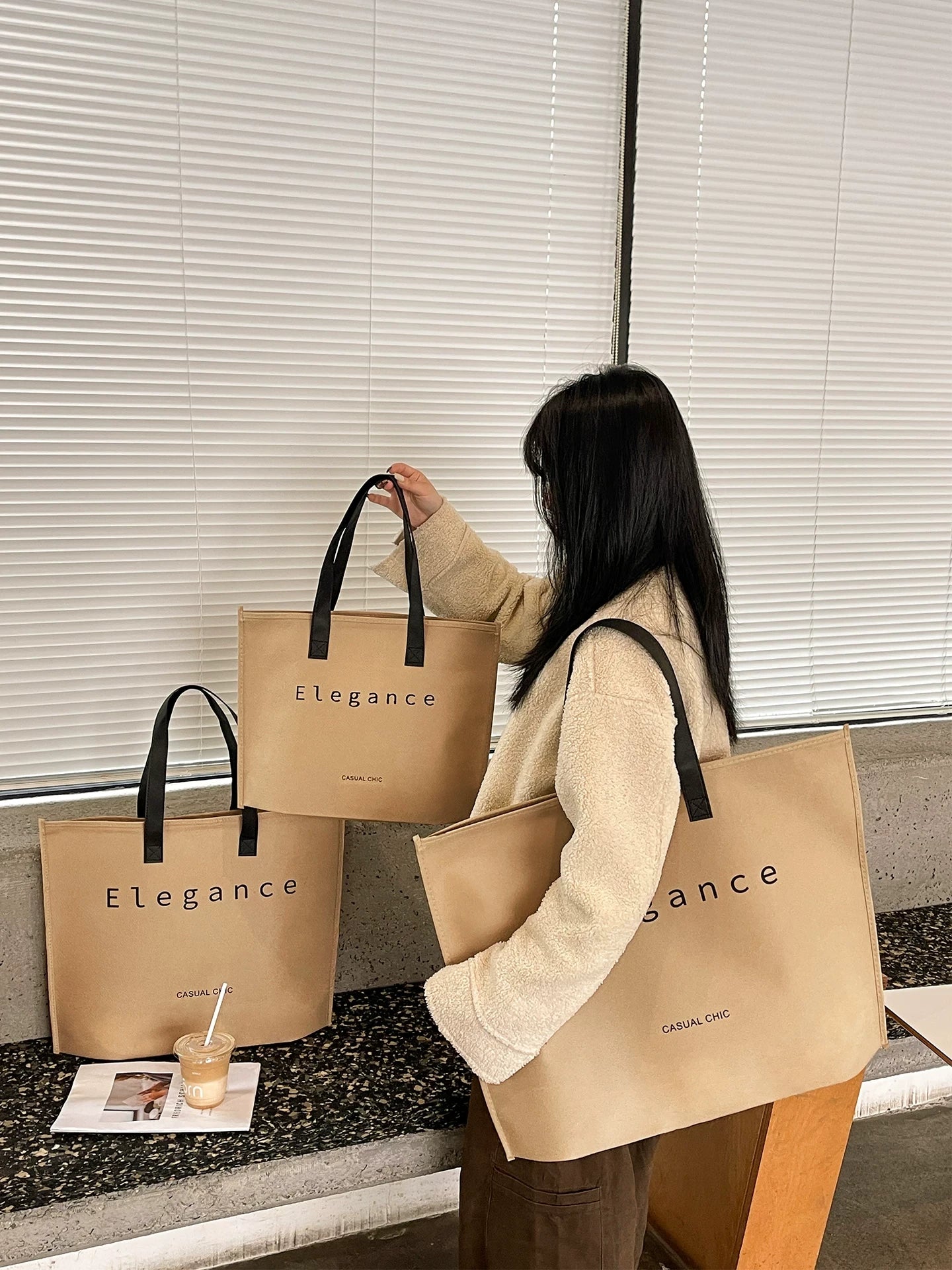 Woman carrying a tan Elegance zipper non-woven tote bag