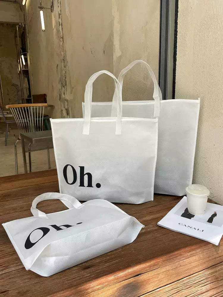 White Oh zippered non-woven tote bags for apparel packaging