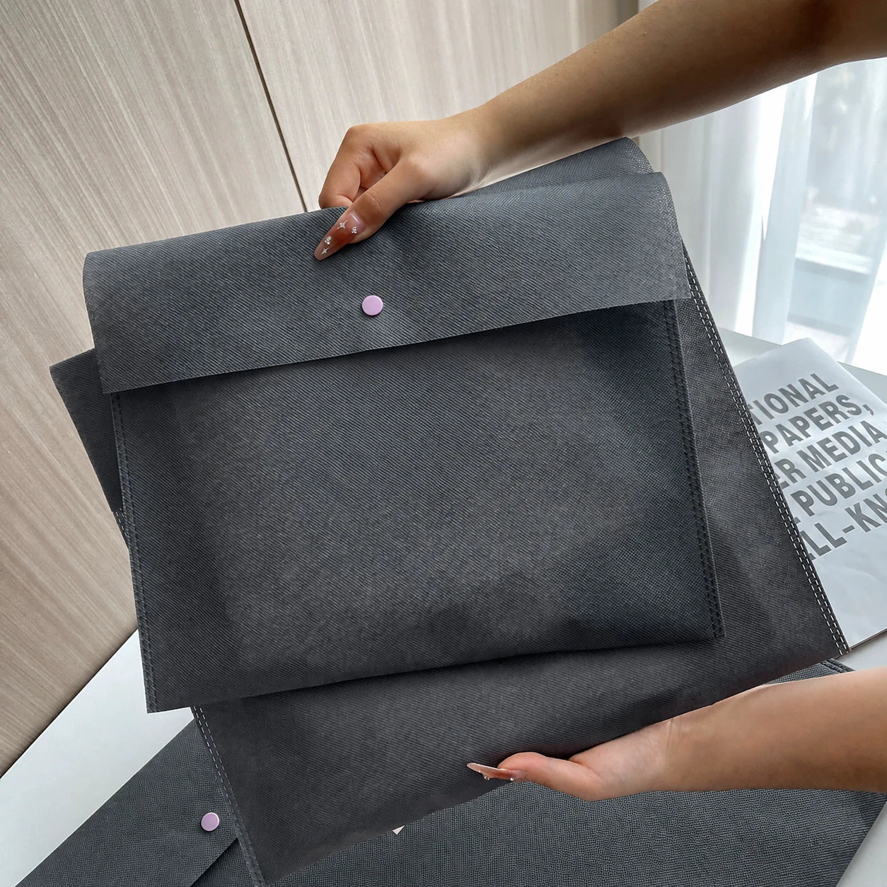 Gray envelope-style non-woven bags with snap closures