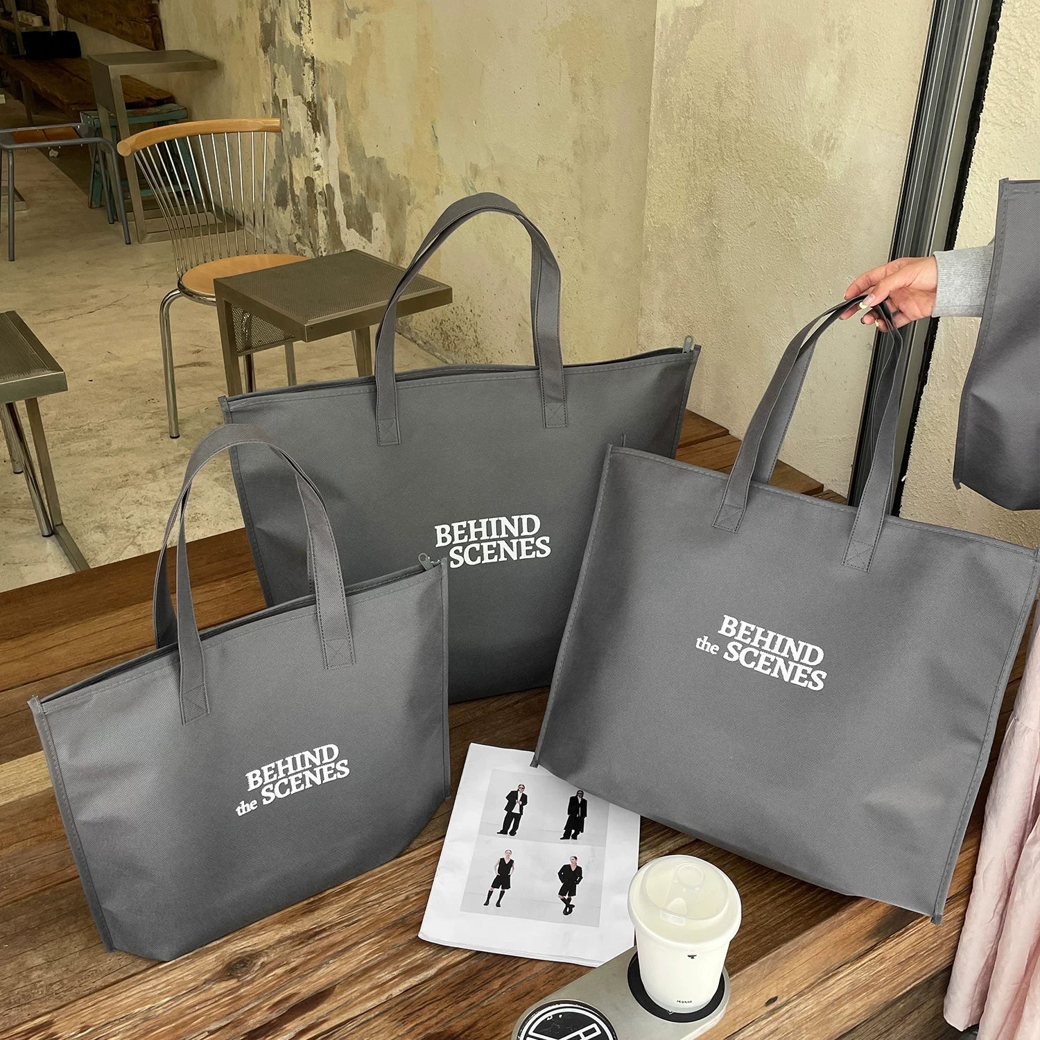 Behind the Scenes gray zippered non-woven tote bag
