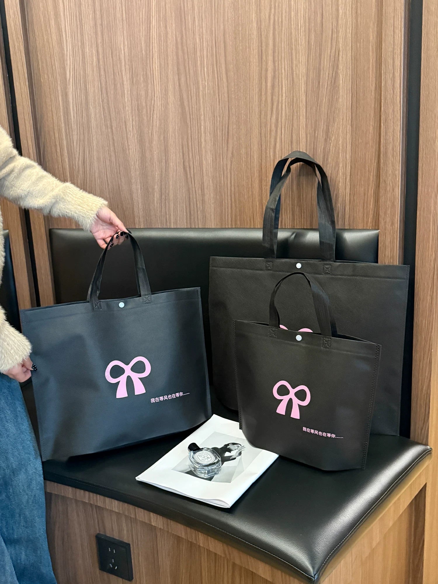 Custom black non-woven tote bags for boutique retail packaging