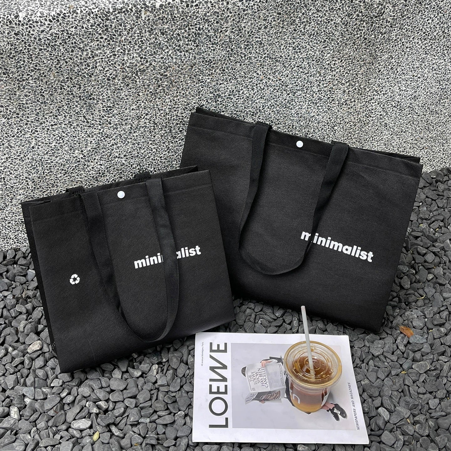 Black non-woven tote bag with mini print and woven handles