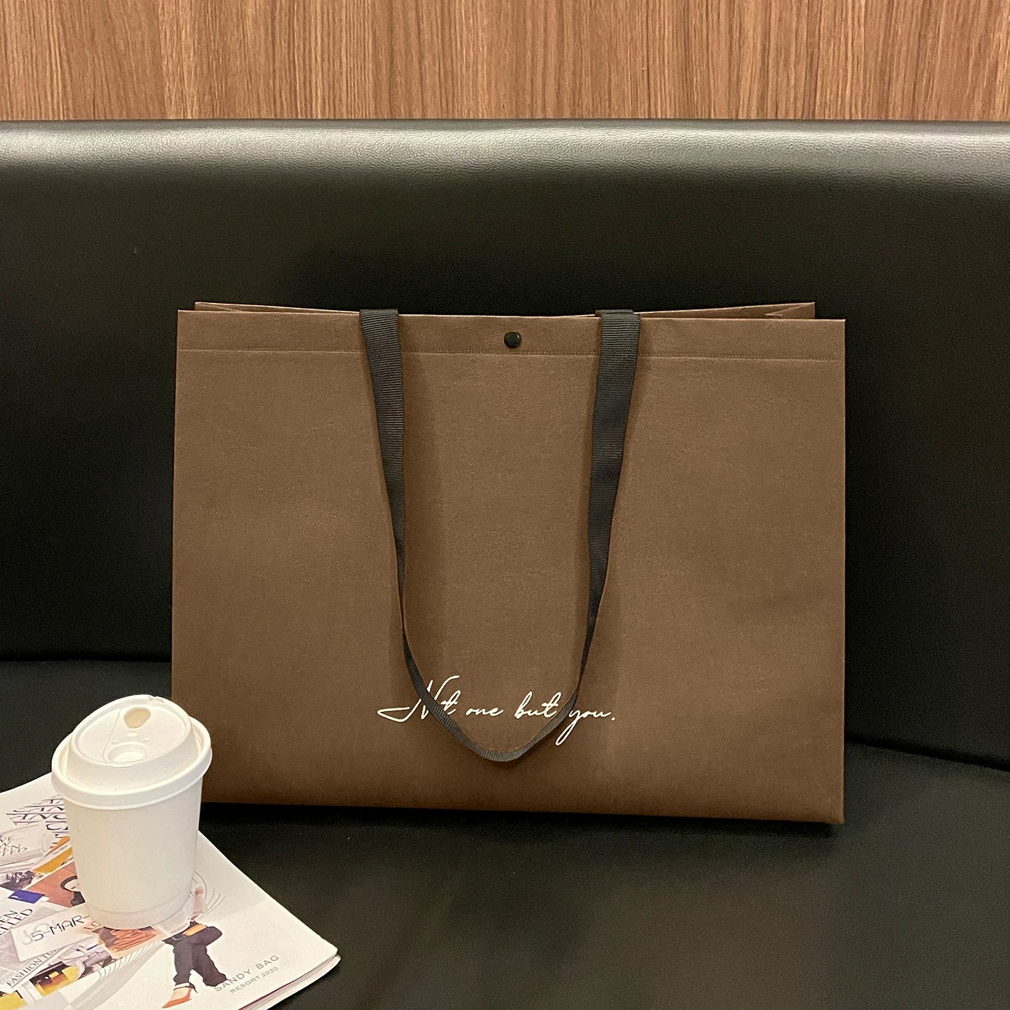 Brown script-print non-woven tote bag with woven handles