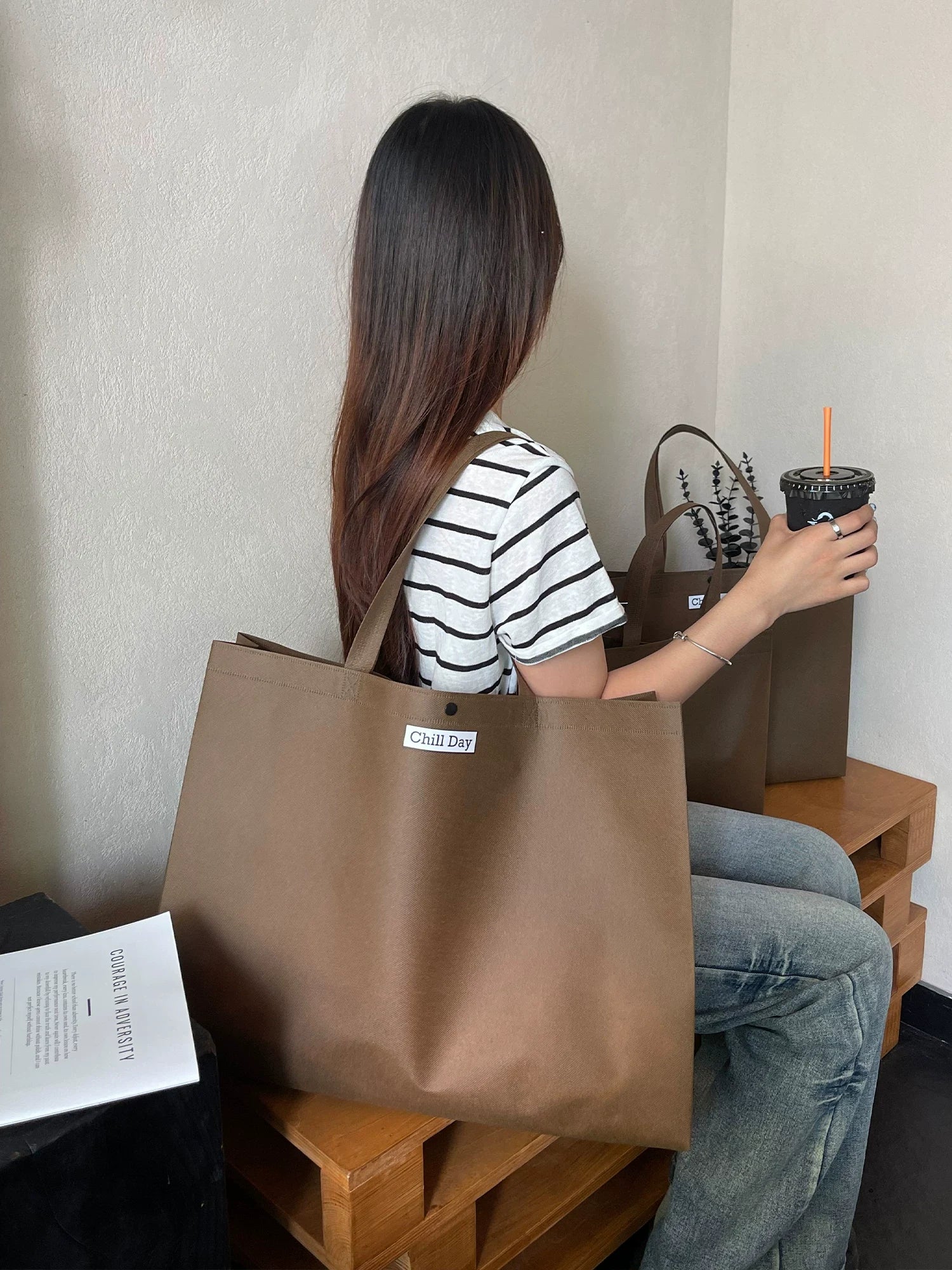 Brown structured non-woven tote bag in a lifestyle setting