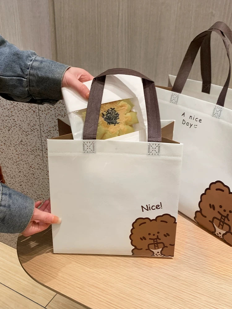Bear design laminated non-woven gift bags in two sizes in a retail setting