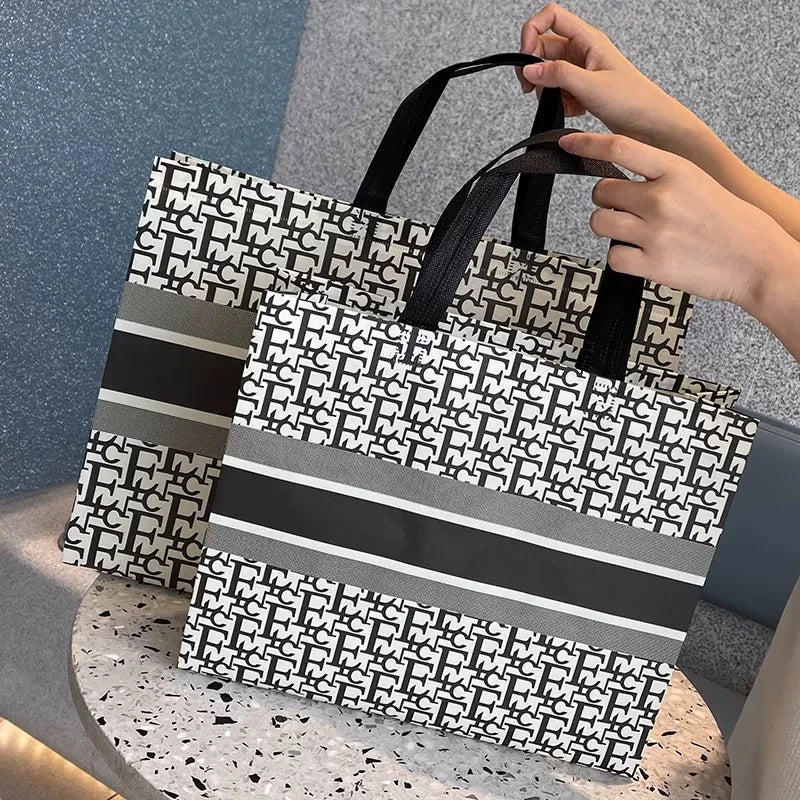 EC monogram laminated non-woven tote bag with a blank center panel
