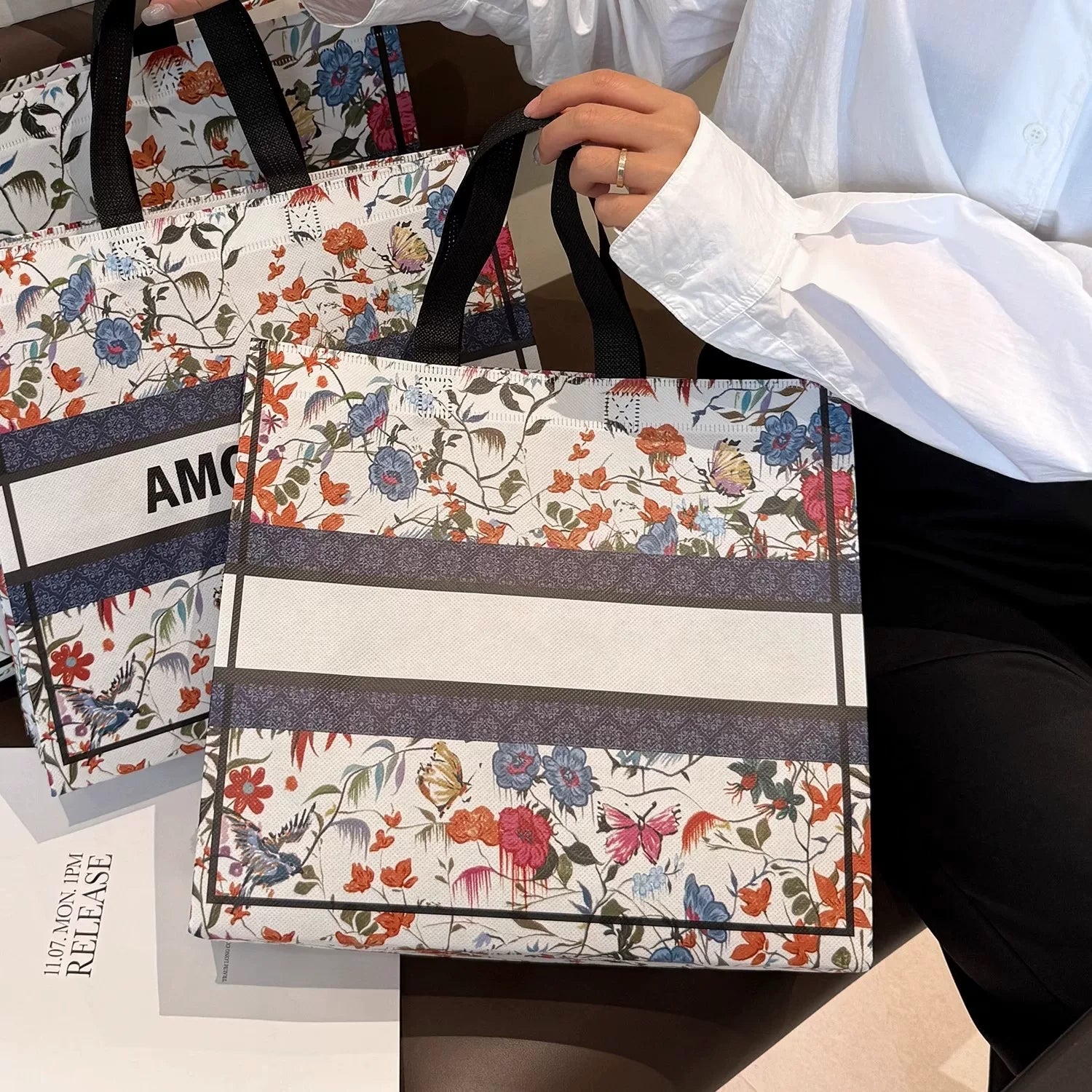 Floral laminated non-woven tote bag with a blank center panel