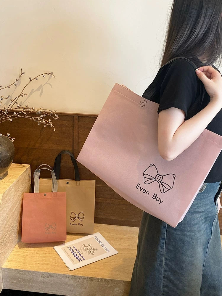 Pink custom non-woven shopping bag in a retail lifestyle setting