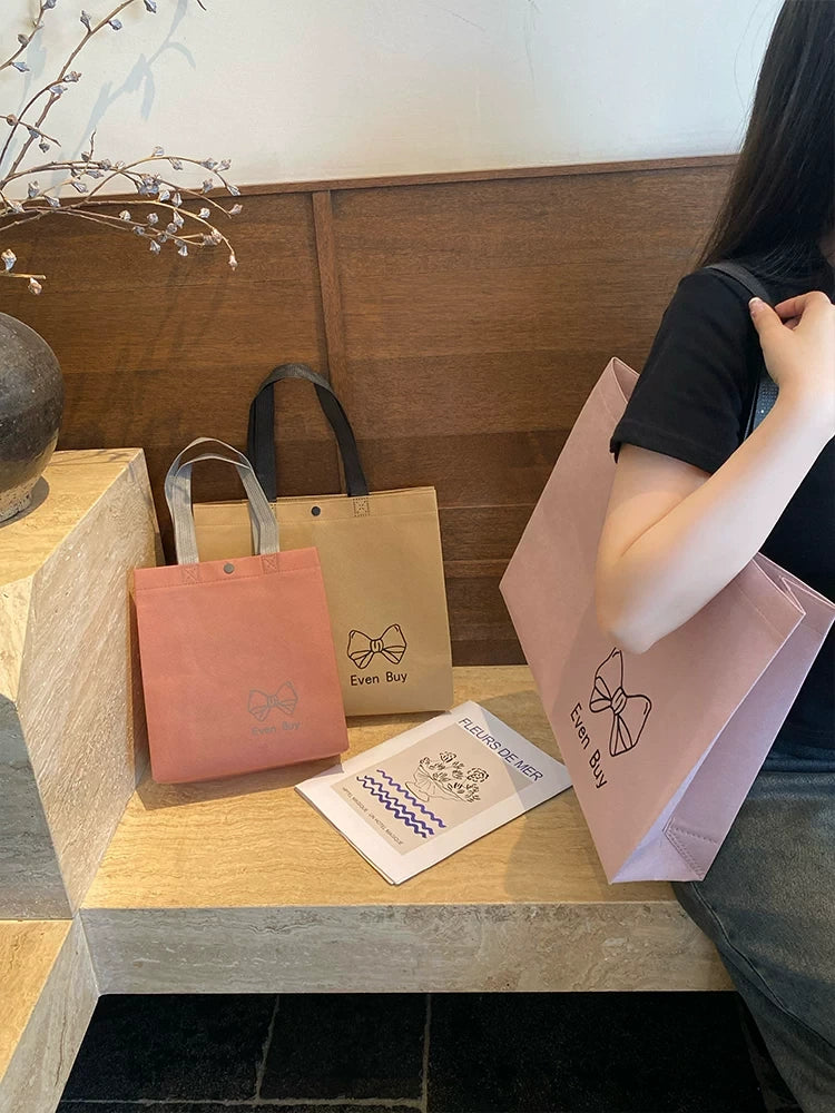 Non-woven tote bags in multiple colors and sizes for retail packaging