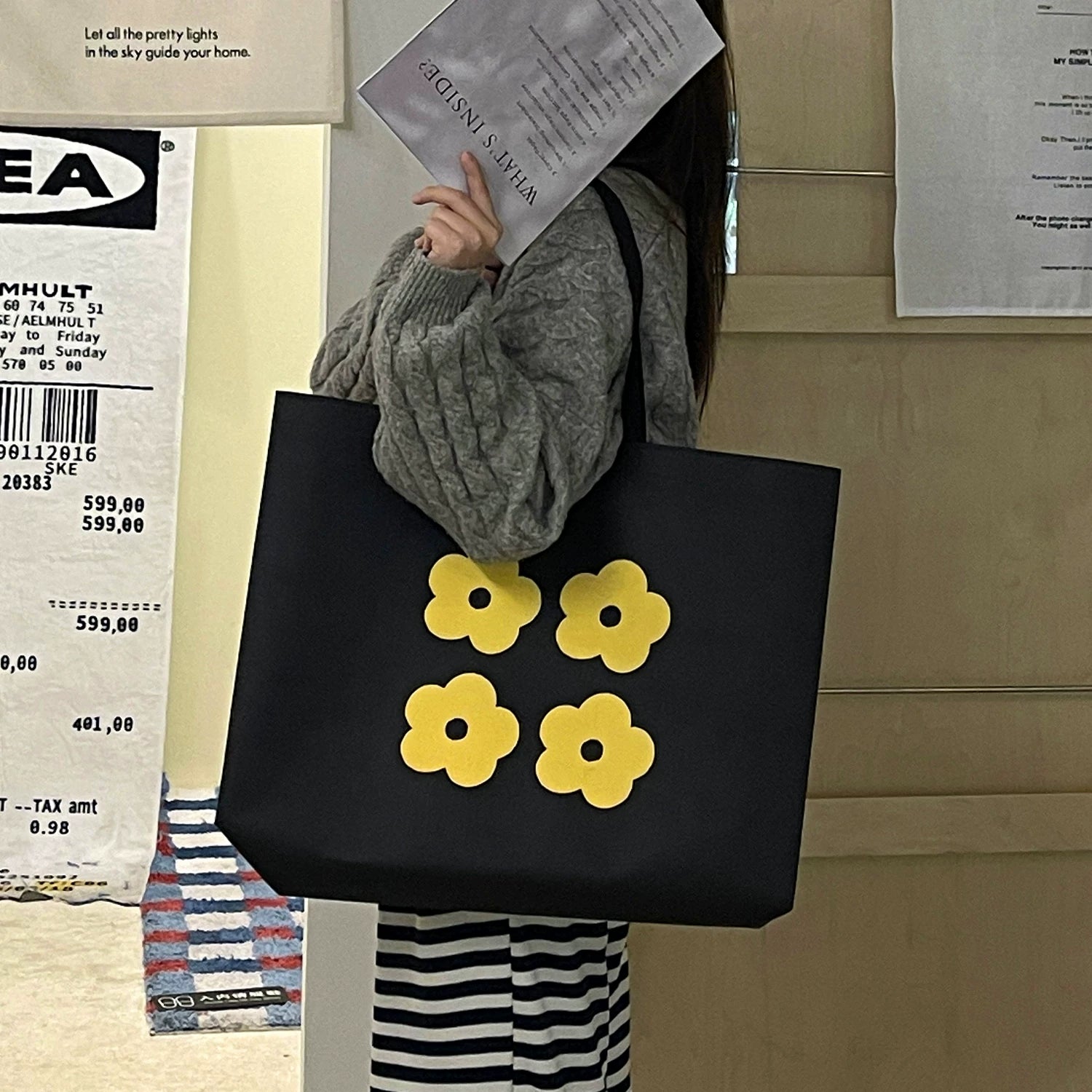 Black non-woven tote bag with yellow flower design