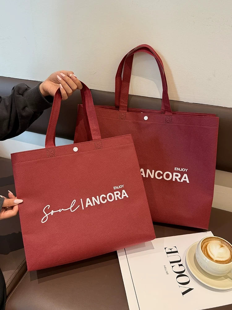 Custom red snap-button non-woven tote bags in two sizes