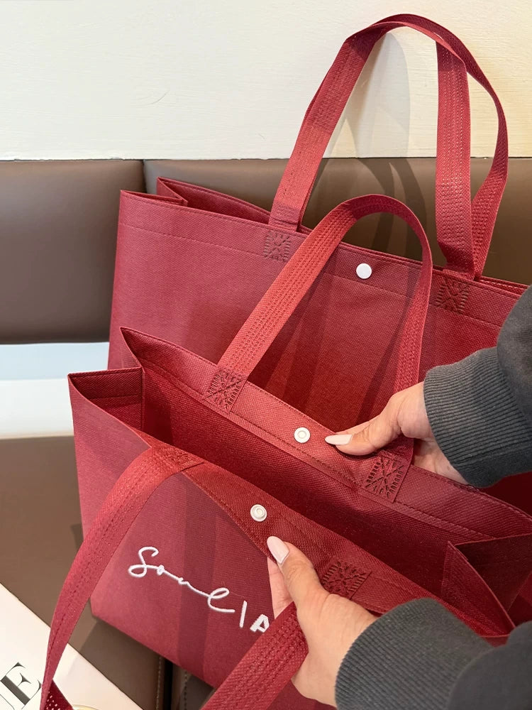 Red snap-button non-woven tote bag construction and side gusset