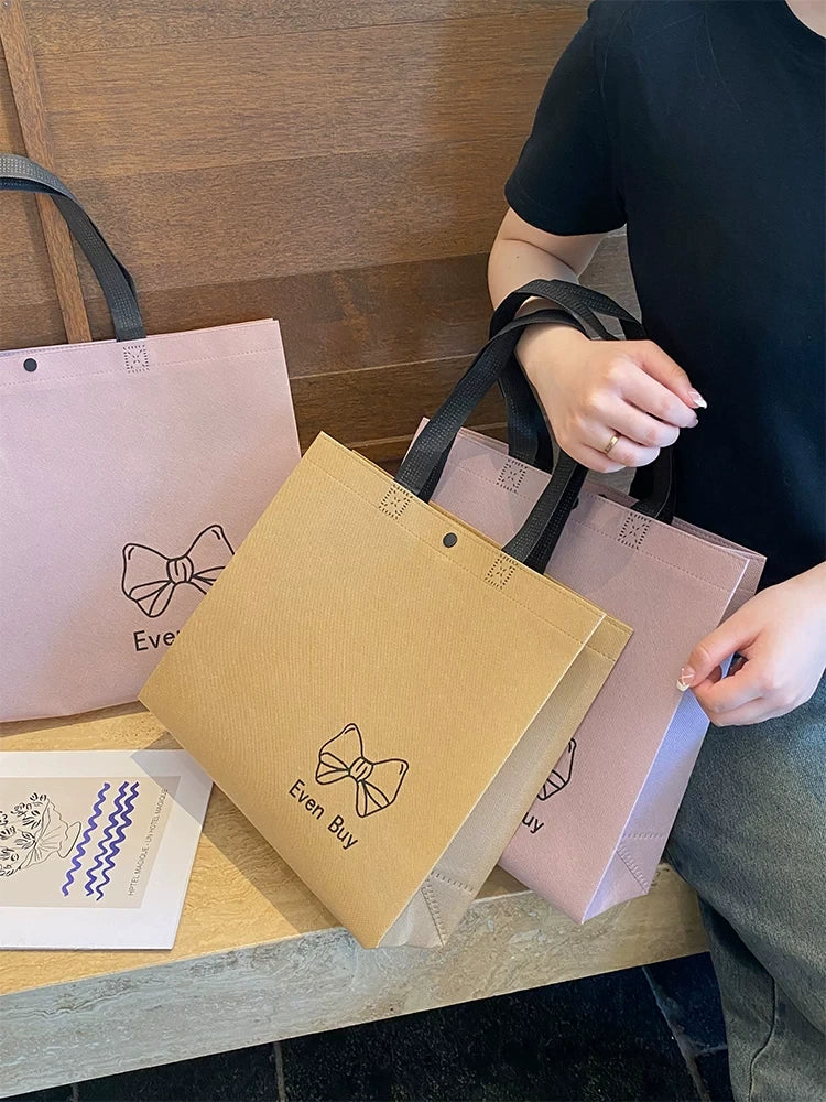 Custom snap-closure non-woven tote bags in pink and khaki