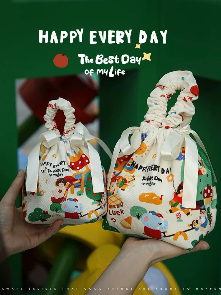 Two ready-stock fabric drawstring gift bags with ribbon bows