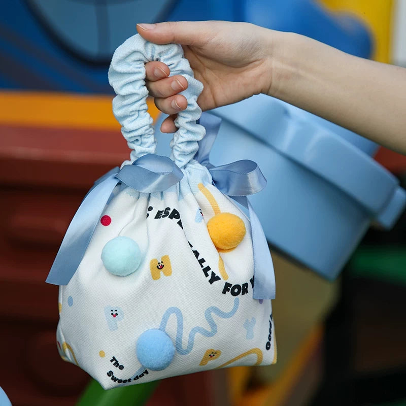 Blue pom-pom fabric drawstring gift bag