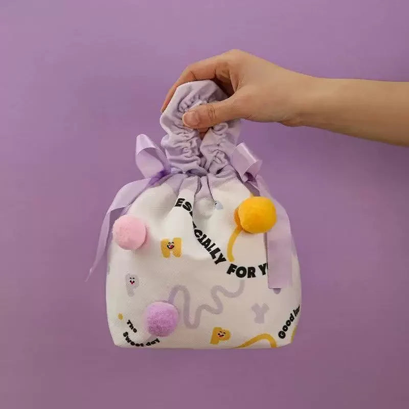 Purple pom-pom fabric drawstring gift bag