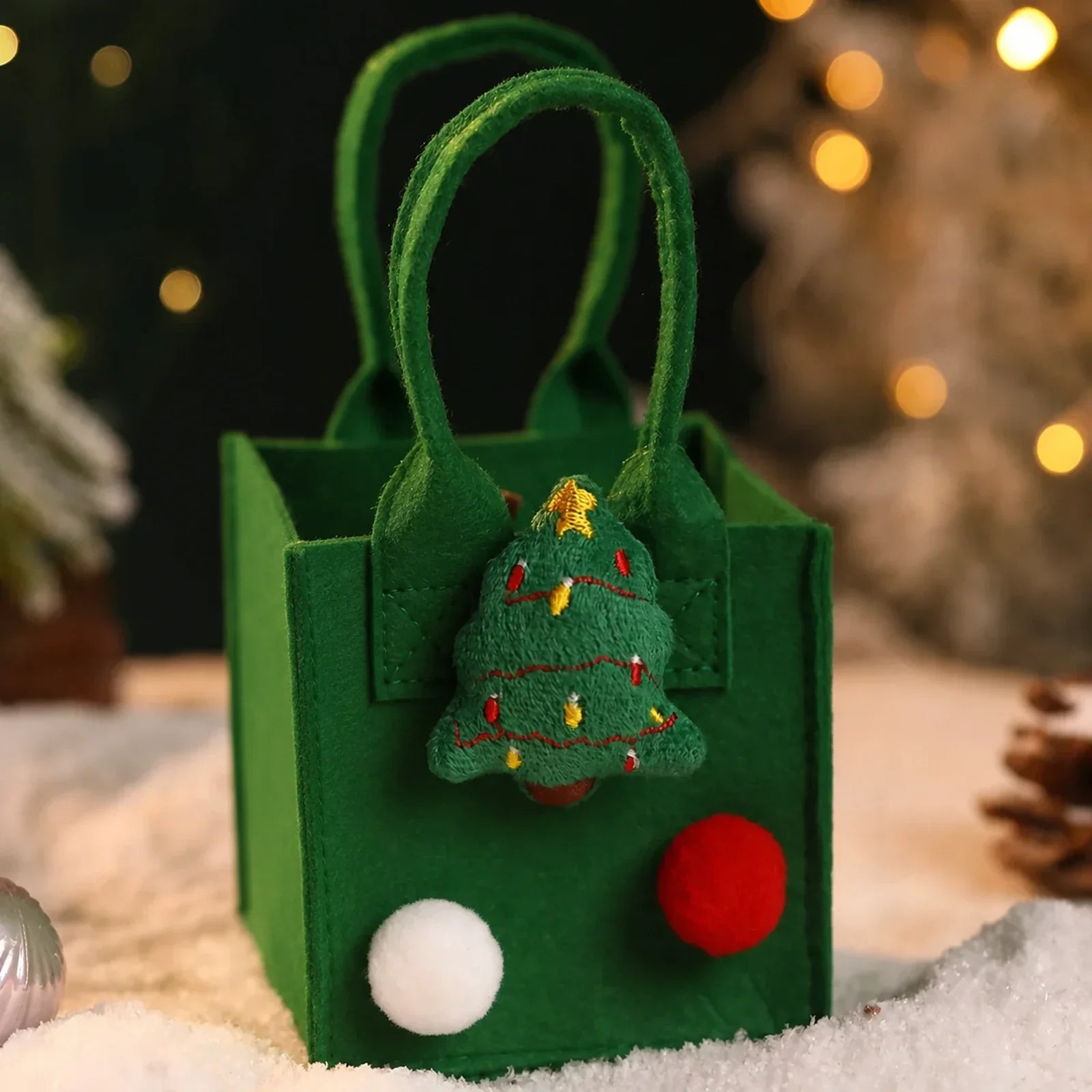 Green felt Christmas gift bag with integrated handles and tree ornament