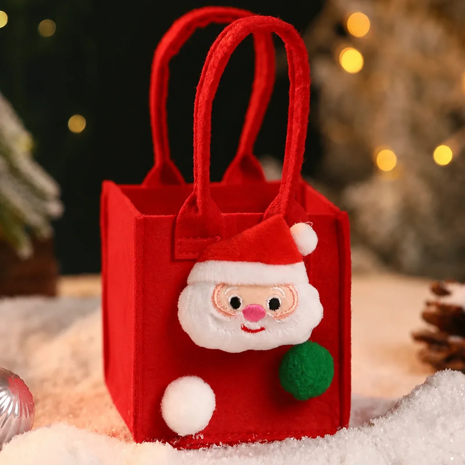 Red felt Christmas gift bag with integrated handles and Santa ornament