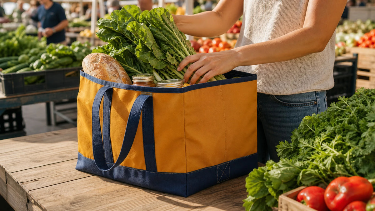 Wide mustard recycled utility carryall loaded with produce at a farmers market