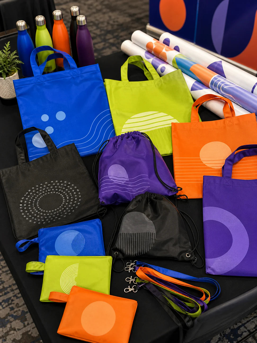 Colorful reusable event bag assortment with totes, drawstring bags and foldable pouches