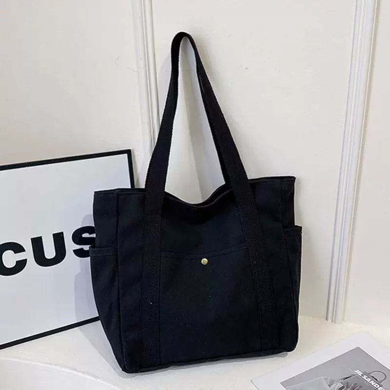 Large-capacity black canvas tote bag with lining, zipper and dual side pockets