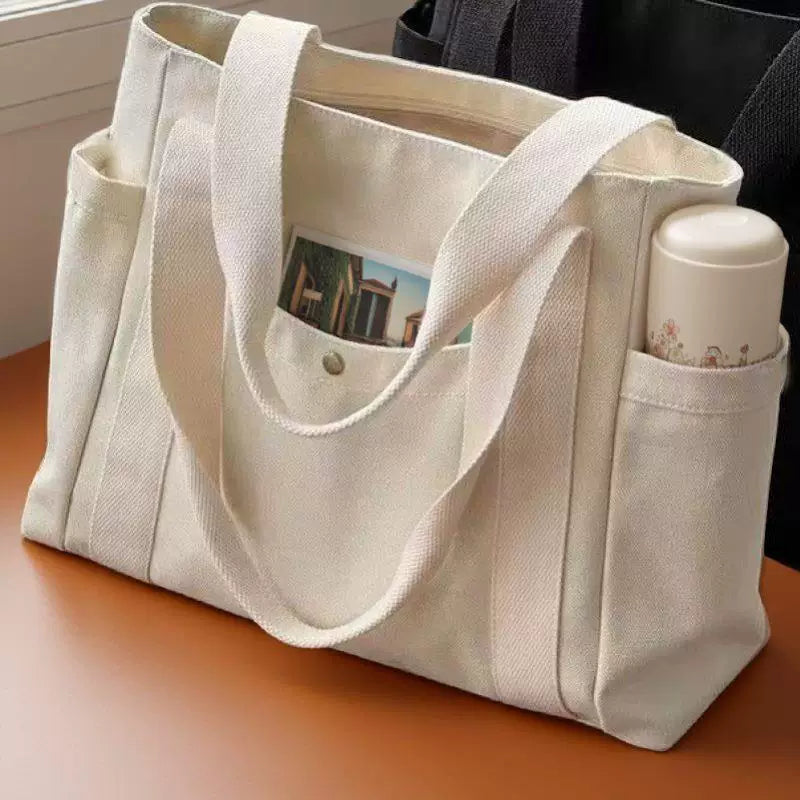 Large-capacity off-white canvas tote bag with lining, zipper and dual side pockets