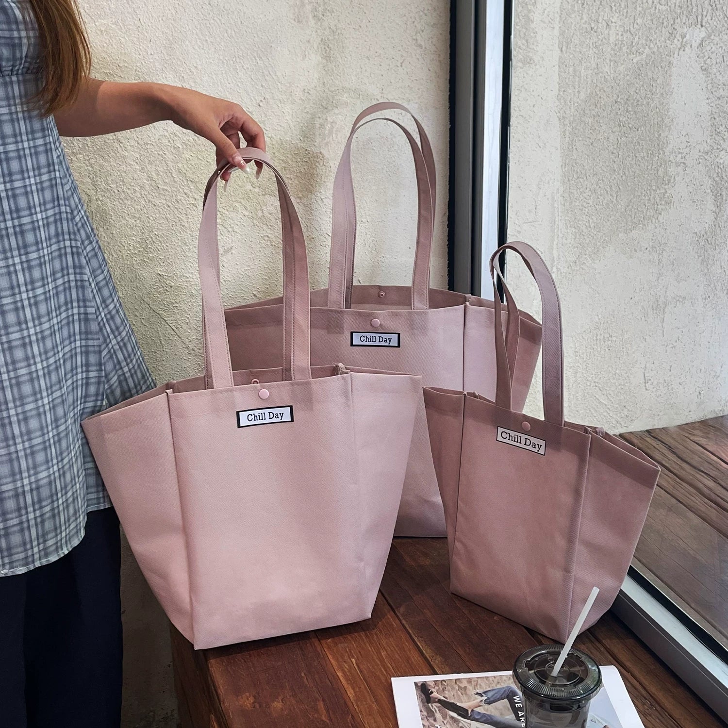 Light purple trapezoid non-woven tote bag with woven label