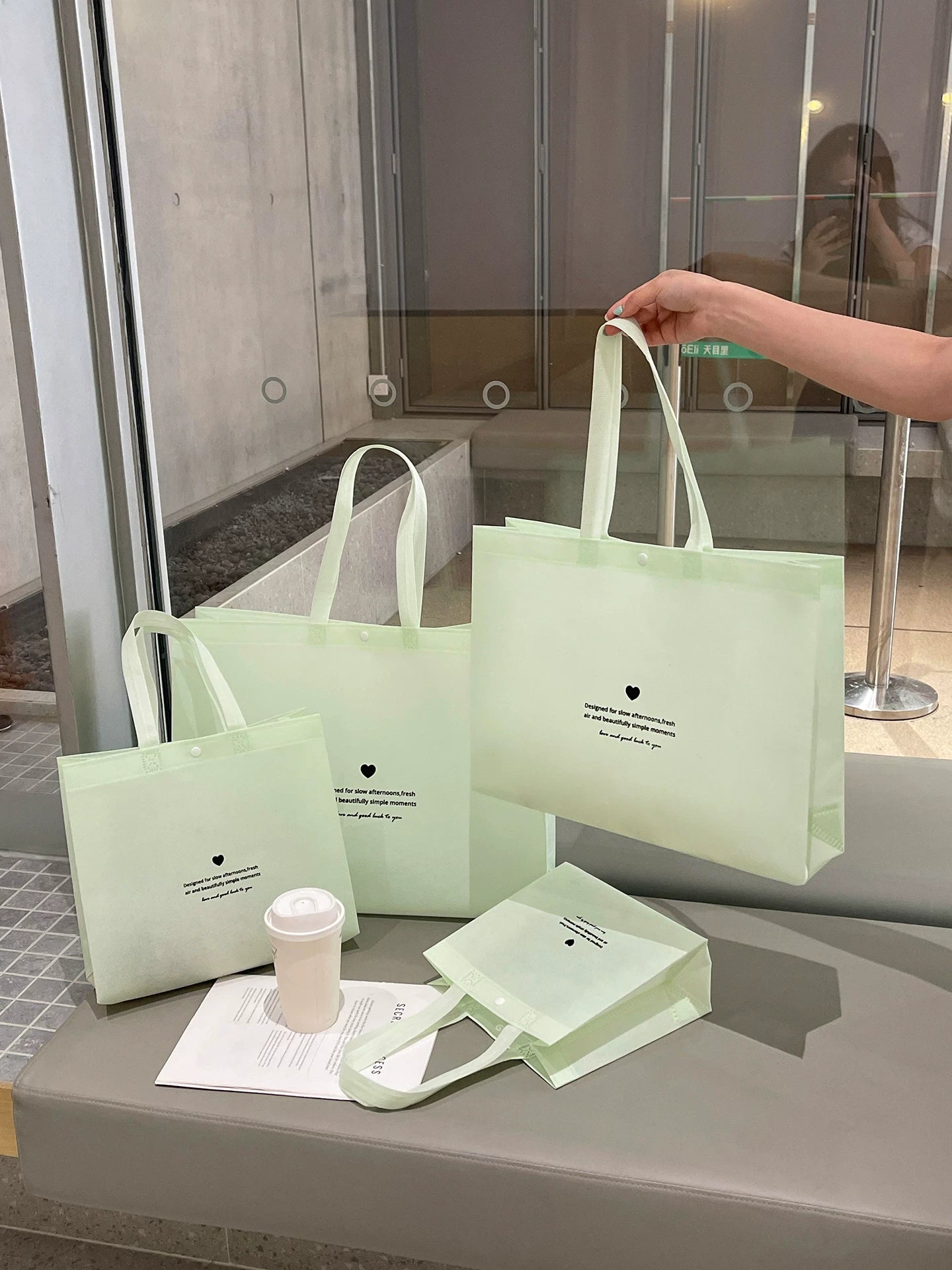 Mint green snap-closure non-woven tote bags in multiple sizes