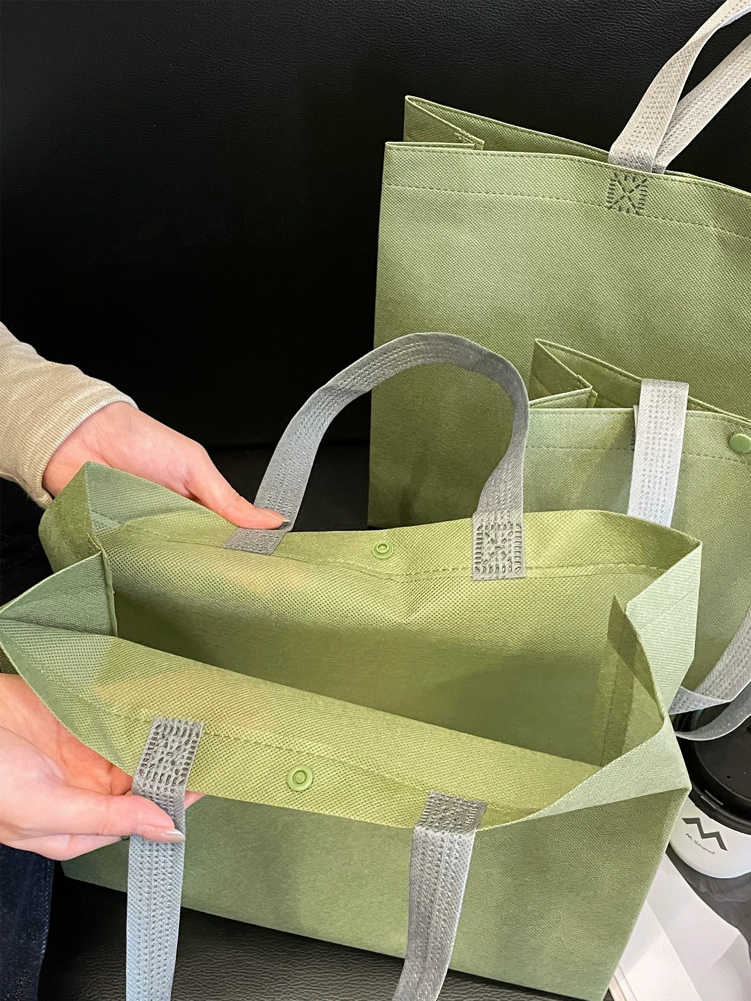 Spacious interior and reinforced handle stitching of non-woven tote bag