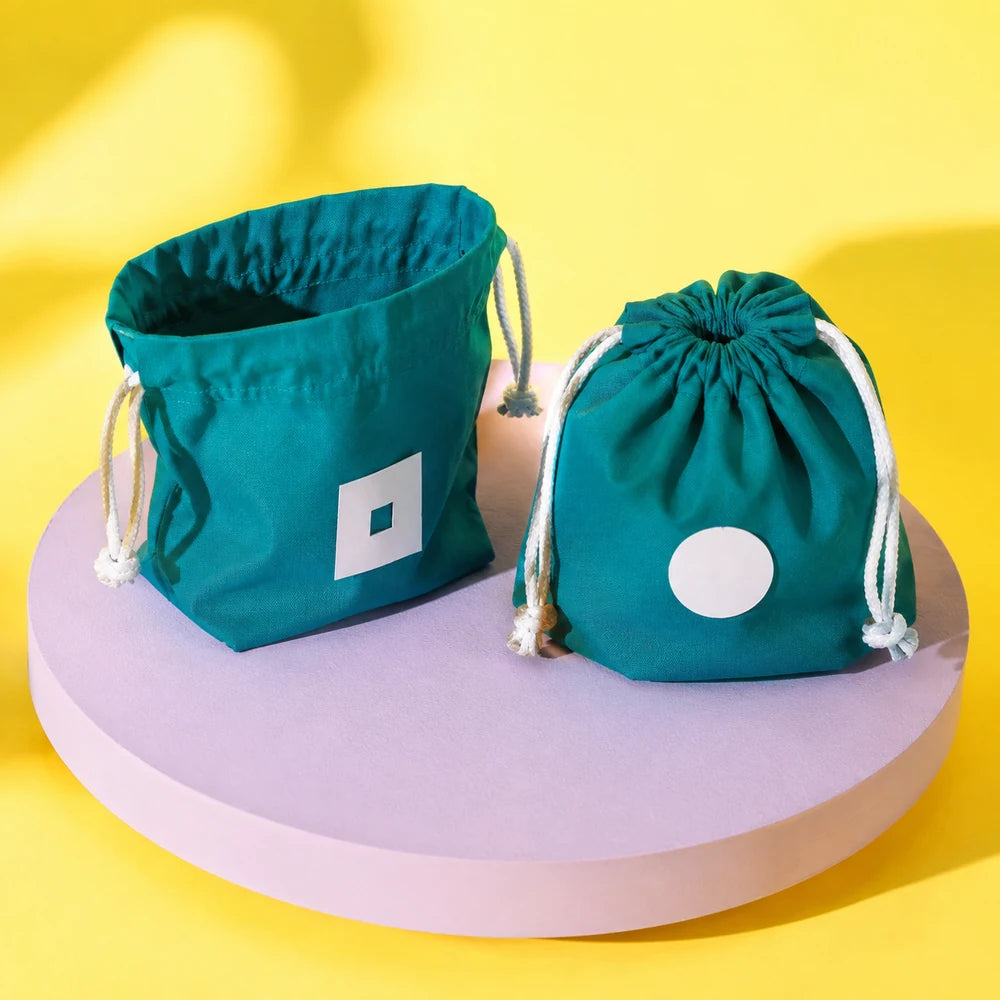 Teal drawstring prototypes showing open and fully cinched closure states