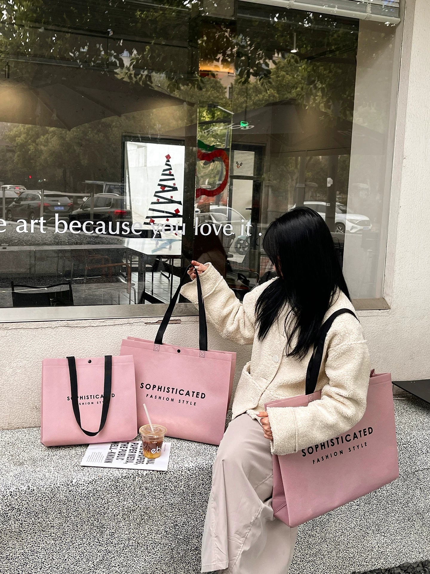 Model carrying pink woven-handle non-woven tote bags