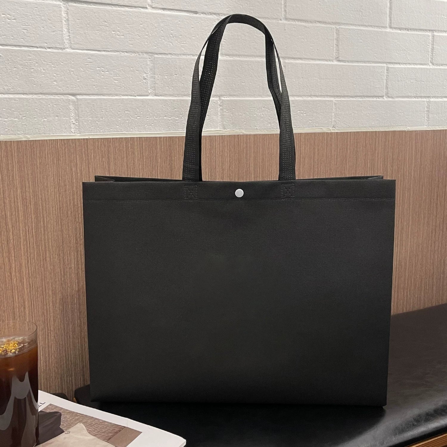 Plain black non-woven tote bag