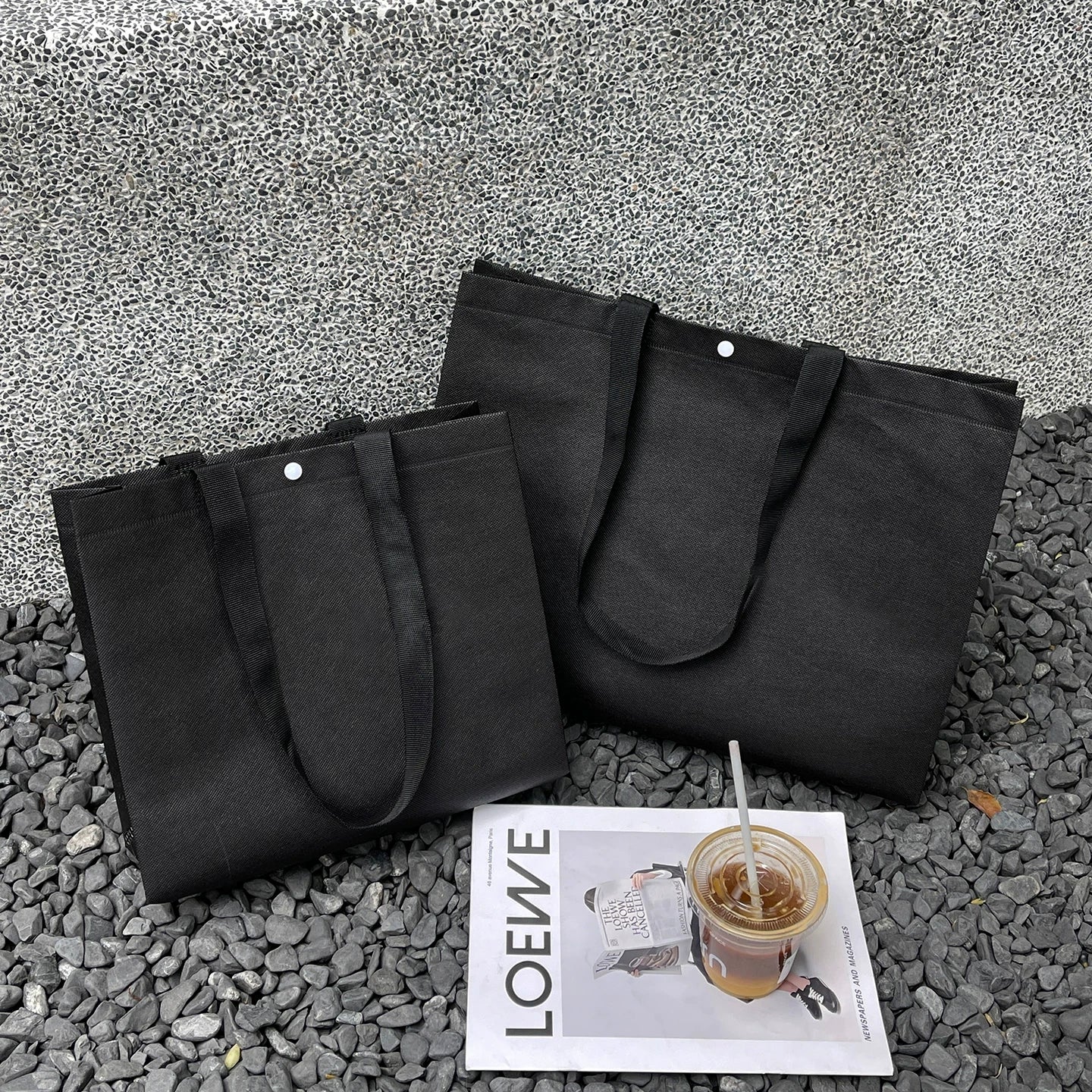 Plain black non-woven tote bag with woven handles