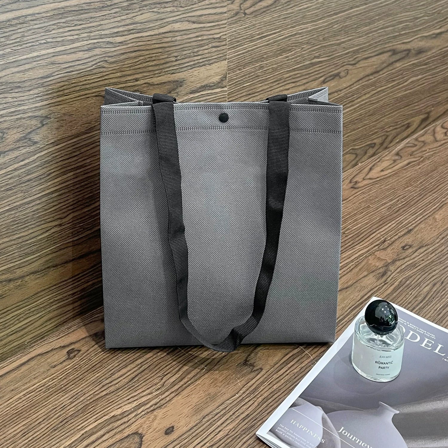 Plain dark gray non-woven tote bag with woven handles