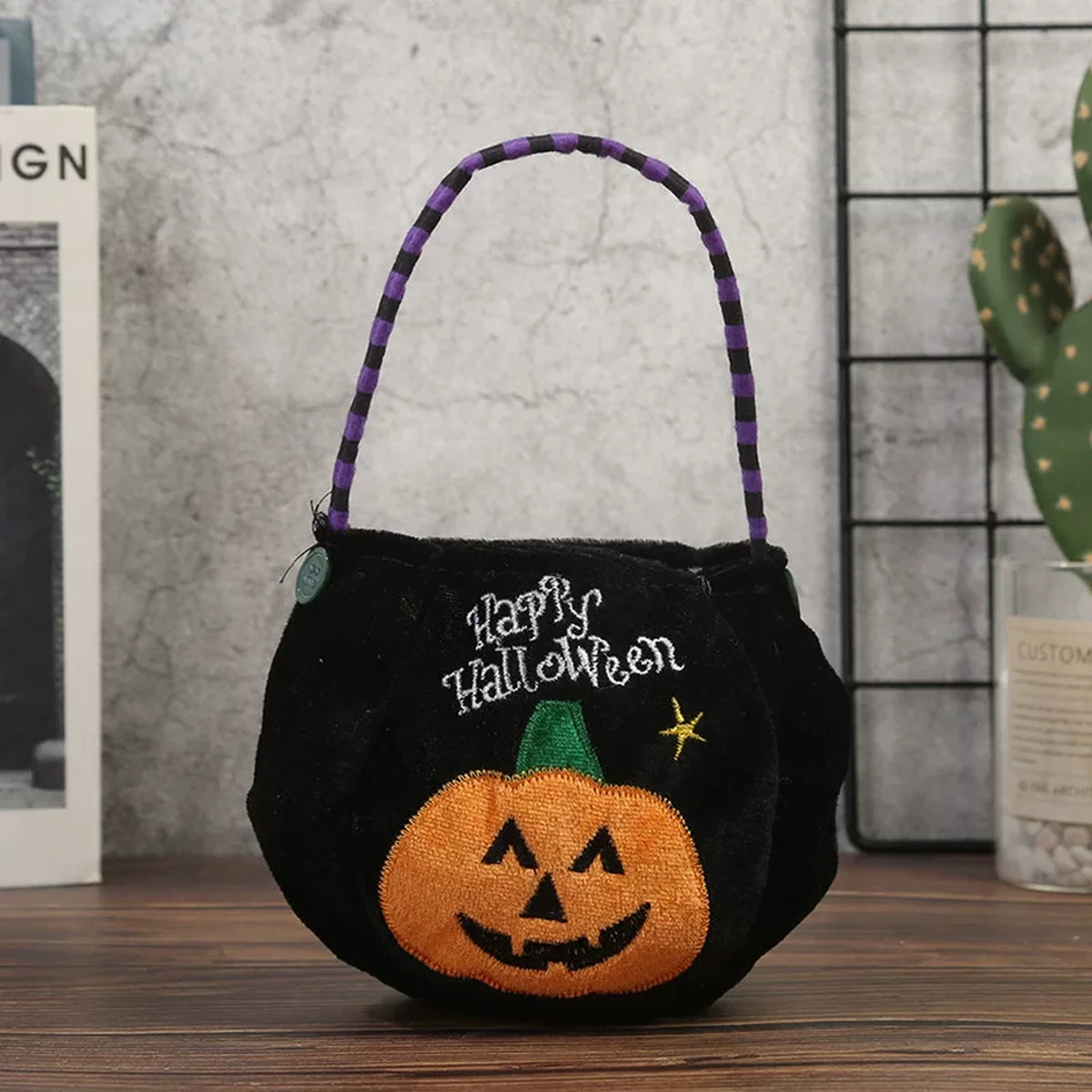 Black plush Halloween bucket bag with pumpkin design