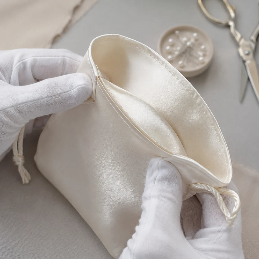 Enclosed French seam inside an ivory satin drawstring pouch